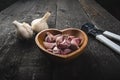 Cloves of garlic on a wooden black table. Fresh garlic bulb with iron garlic press. Vintage background. Farmer. Medicine and healt Royalty Free Stock Photo