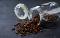 cloves spice spill out of a glass storage jar on a black kitchen table, selective focus Royalty Free Stock Photo