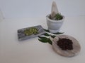 Cloves and Cardamom with mortar grinder on a plain white background