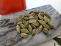 Cloves and Cardamom with mortar grinder on a plain white background