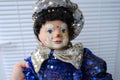 clown in blue shiny suit, abandonment, loss and resilience, source of companionship and emotions, potential of clown doll as