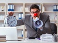 Clown businessman angry in the office with a megaphone Royalty Free Stock Photo