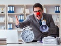 Clown businessman in the office angry frustrated with megaphone Royalty Free Stock Photo