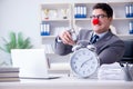 Clown businessman working in the office angry frustrated with a Royalty Free Stock Photo