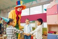 Clown with cheerful children play counting game