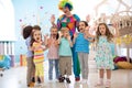 Clown and children playing indoor . Holiday in a children`s club. Games with animator