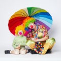 Clown with colorful umbrella on white Royalty Free Stock Photo