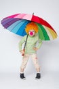 Clown with colorful umbrella on white Royalty Free Stock Photo