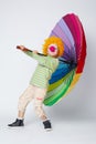 Clown with colorful umbrella on white Royalty Free Stock Photo