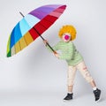 Clown with colorful umbrella on white Royalty Free Stock Photo