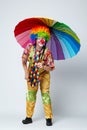 Clown with colorful umbrella on white Royalty Free Stock Photo