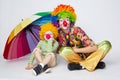 Clown with colorful umbrella on white Royalty Free Stock Photo