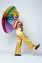 Clown with colorful umbrella on white Royalty Free Stock Photo