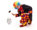 Clown hitting alarm clock with hammer