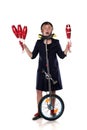 Clown with juggling clubs and a unicycle Royalty Free Stock Photo