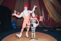 clown man on roller skates with his little assistant girl of his stage persona. Royalty Free Stock Photo