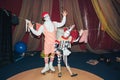 clown man on roller skates with his little assistant girl of his stage persona. Royalty Free Stock Photo