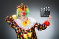 Clown with movie clapper in funny concept Royalty Free Stock Photo