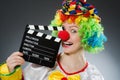 Clown with movie clapper in funny concept Royalty Free Stock Photo