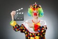 Clown with movie clapper in funny concept Royalty Free Stock Photo