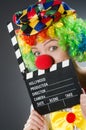 Clown with movie clapper in funny concept Royalty Free Stock Photo