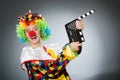 Clown with movie clapper in funny concept Royalty Free Stock Photo