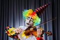 Clown playing on violin