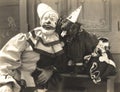 Clown posing with dog dressed in clown costume Royalty Free Stock Photo