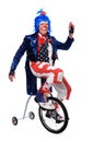 Clown Riding Unicycle with Training Wheels Royalty Free Stock Photo