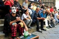 Clown street artist in Italy performing in front of a crowd in Florence city