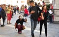 Clown street artist in Italy performing in front of a crowd in Florence city