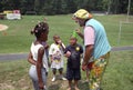 A clown talks to several small children