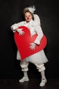 Clown Woman posing with red heart, studio portrait Royalty Free Stock Photo