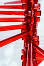 Clsoe-up selective focus view of a sereis of symmetrical red rods on a shaft Royalty Free Stock Photo