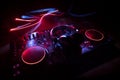 DJ console deejay-mixing desk in dark with colorful light. Mixer equipment entertainment DJ station Royalty Free Stock Photo