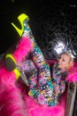 Club party blonde girl in acid anime style spandex catsuit with mirror car with pink fur ready for crazy clubbing life