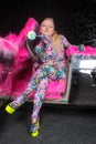 Club party blonde girl in acid anime style spandex catsuit with mirror car with pink fur ready for crazy clubbing life Royalty Free Stock Photo