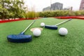 A club prepares to hit a ball during a mini golf game