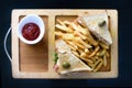 Chicken club sandwich on a white plate with spicy french fries. Royalty Free Stock Photo