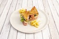 club sandwich with chicken, bacon, iceberg lettuce and ham, french fries, red onion, Royalty Free Stock Photo
