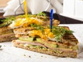 Club sandwich with egg, cucumber, tomato, ham Royalty Free Stock Photo