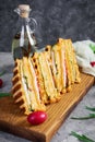 Club sandwich with ham, cheese, tomato and salad. Grilled sandwich with dried tomatoes bread Royalty Free Stock Photo