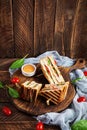 Club sandwich with ham, tomato, cheese and spinach. Grilled panini