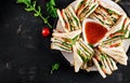 Club sandwich with ham, tomato, cucumber, cheese, and arugula Royalty Free Stock Photo