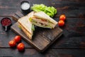 Club sandwich panini with ham, tomato, cheese, on dark wooden background Royalty Free Stock Photo