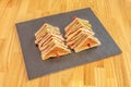 club sandwich skewered with layers of chicken fillet, ham and cheese in tranchetes, lettuce and tomato, mayonnaise and mustard Royalty Free Stock Photo