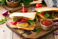 Sandwich with tomatoes, cheese, crispy chicken nuggets and arugula. Delicious fresh homemade club sandwich with chicken on a Royalty Free Stock Photo