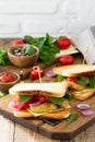 Sandwich with tomatoes, cheese, crispy chicken nuggets and arugula. Delicious fresh homemade club sandwich with chicken on a Royalty Free Stock Photo