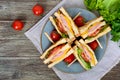 Club-sandwiches with crispy toast, sausage, cheese, tomato, greens.