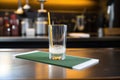 club soda glass with a cocktail stirrer on a modern bar mat